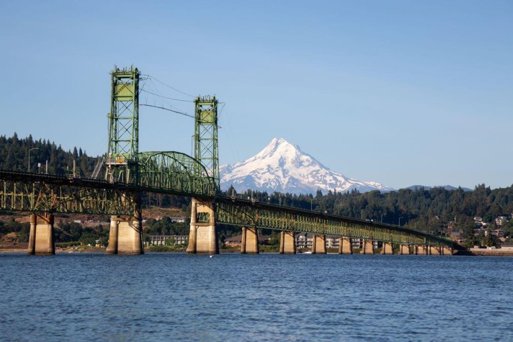 Hood River Bridge crosses the Columbia River with snow-capped Mount Hood in the background.